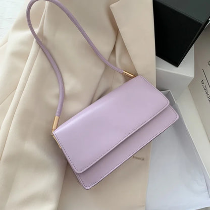 Slim rectangular flap shoulder bag with gold-tone strap accents — lilac on cream fabric | BTendance