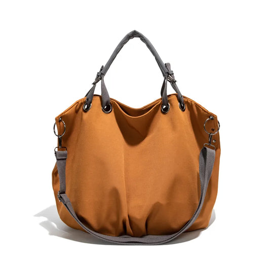 Slouchy nylon shoulder bag with contrasting grey handles — ochre front view on white background | BTendance