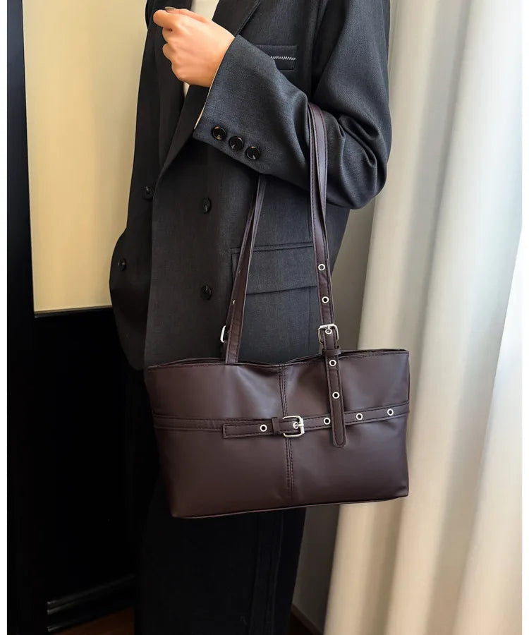 Rectangular shoulder tote with buckle and eyelet detailing — brown worn on shoulder | BTendance