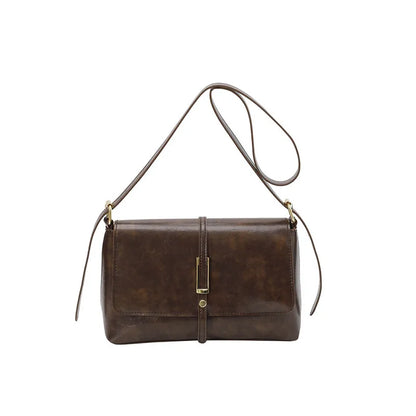 Rectangular flap shoulder bag with slim metal front detail — brown on white background | BTendance