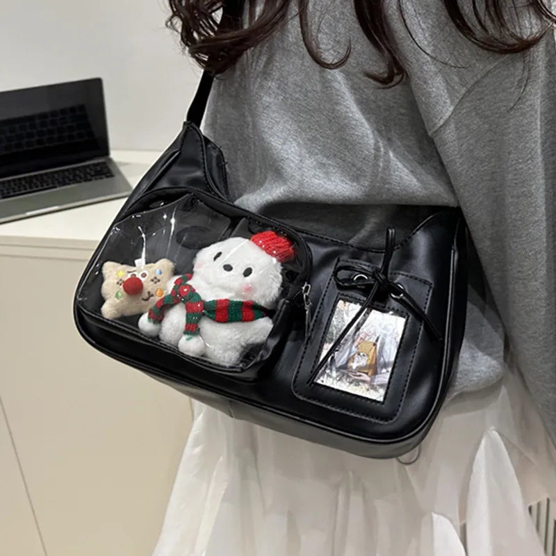 Shoulder bag with clear front display pocket — black carried with plush decorations in clear pocket | BTendance