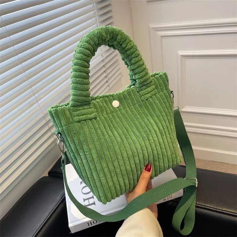 Ribbed plush handbag with rounded handles and long strap — green held near window | BTendance