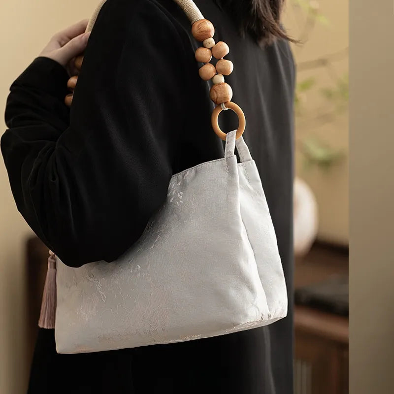 Floral shoulder bag with beaded handle – Pale ivory bag worn on the shoulder | BTendance