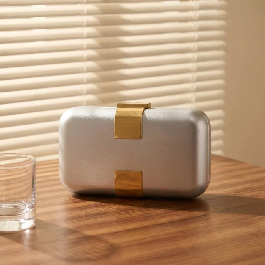 Rectangular evening clutch — silver front view on wooden cabinet | BTendance
