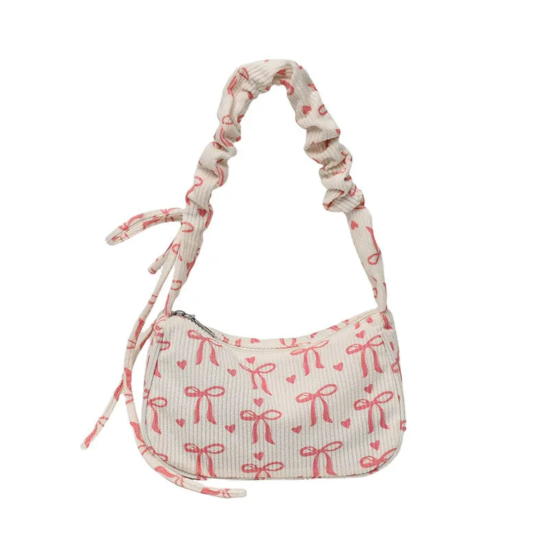 Bow-print corduroy shoulder bag with gathered handle — cream front view on white background | BTendance