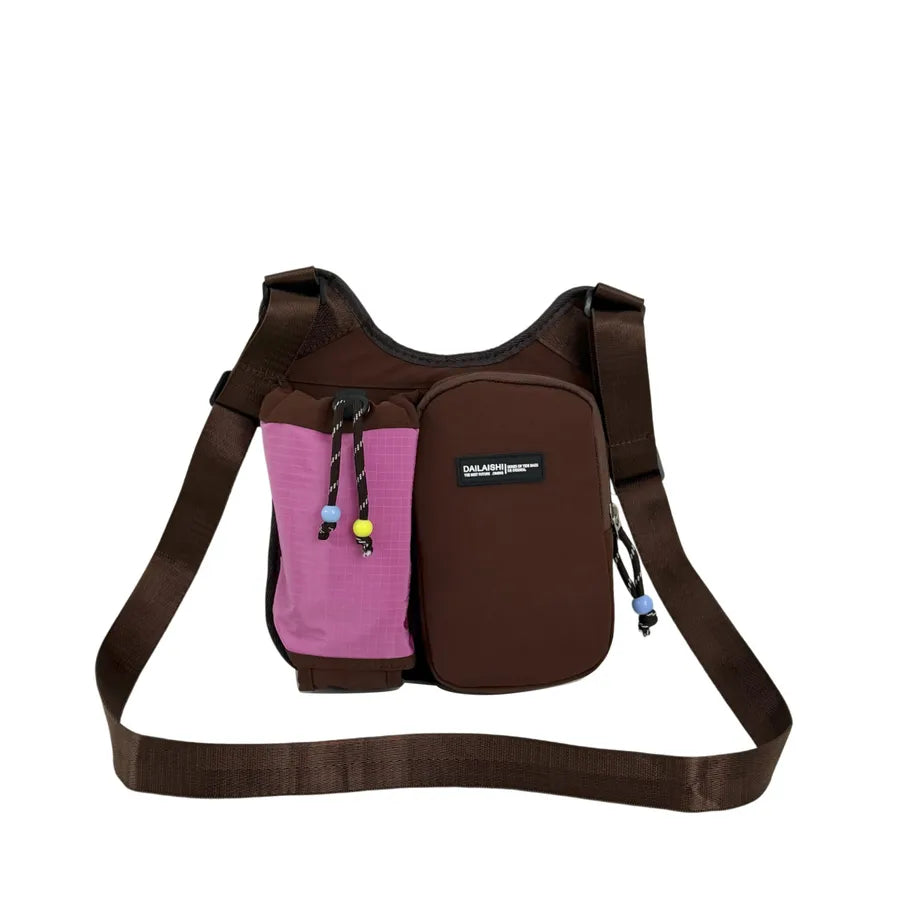Crossbody bag with mesh bottle pocket and front zip pouch — brown with pink pocket on white background | BTendance