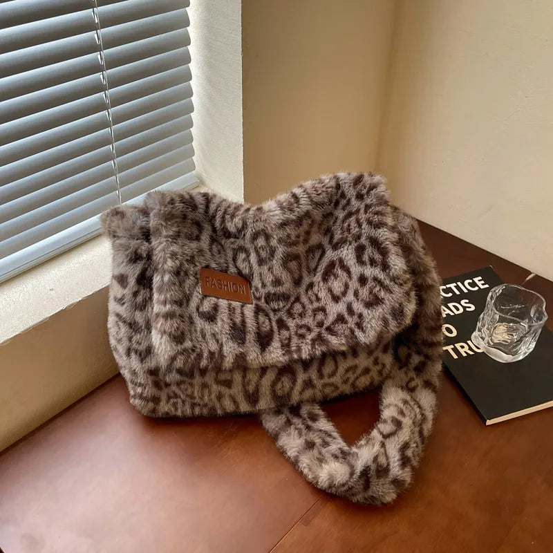 Leopard-print plush shoulder bag — grey leopard print on table | BTendance