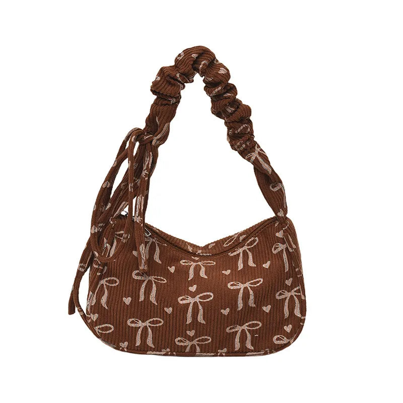Bow-print corduroy shoulder bag with gathered handle — brown front view on white background | BTendance