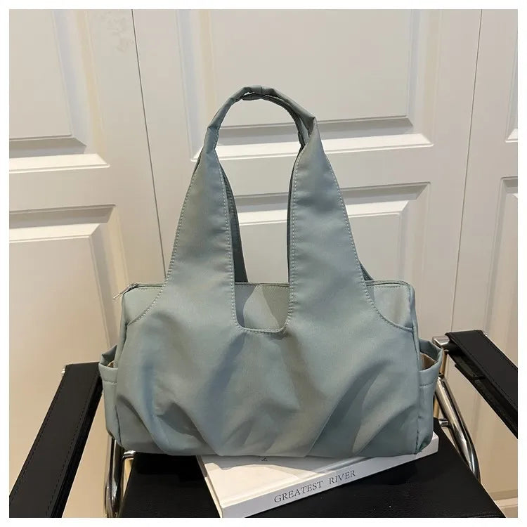 Soft shoulder tote with wide handles and side pockets — blue-grey on chair | BTendance