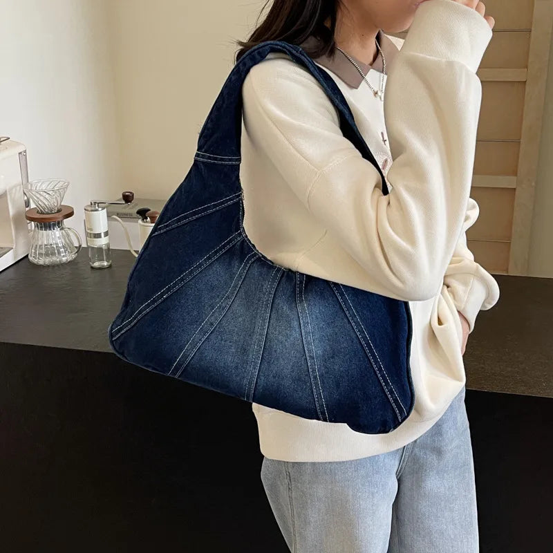 Denim shoulder bag with panel seams – Dark blue bag worn on the shoulder | BTendance