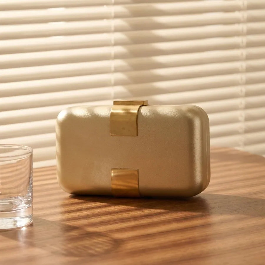 Rectangular evening clutch — gold front view on wooden cabinet | BTendance