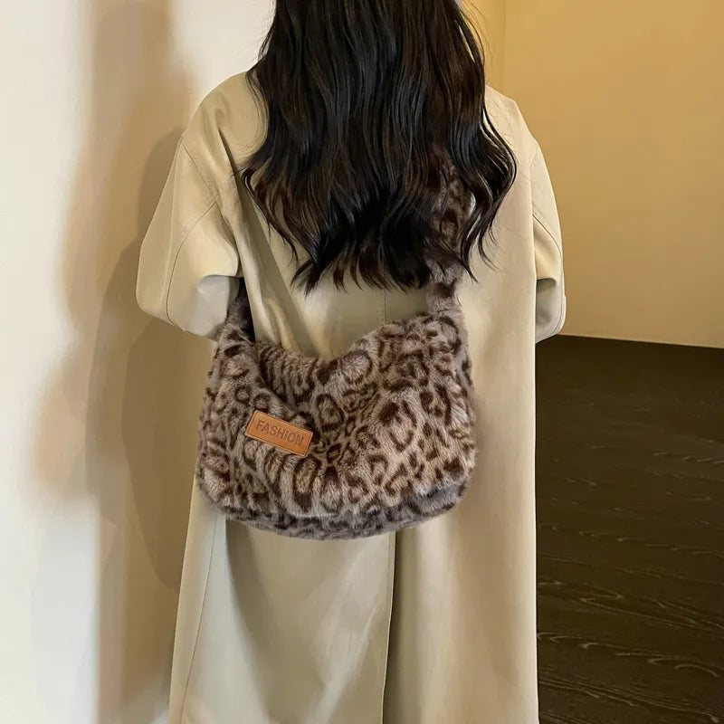 Leopard-print plush shoulder bag — grey worn over cream coat | BTendance