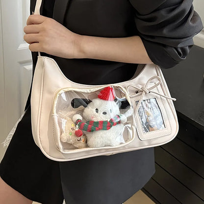 Shoulder bag with clear front display pocket — cream carried with plush decorations in clear pocket | BTendance