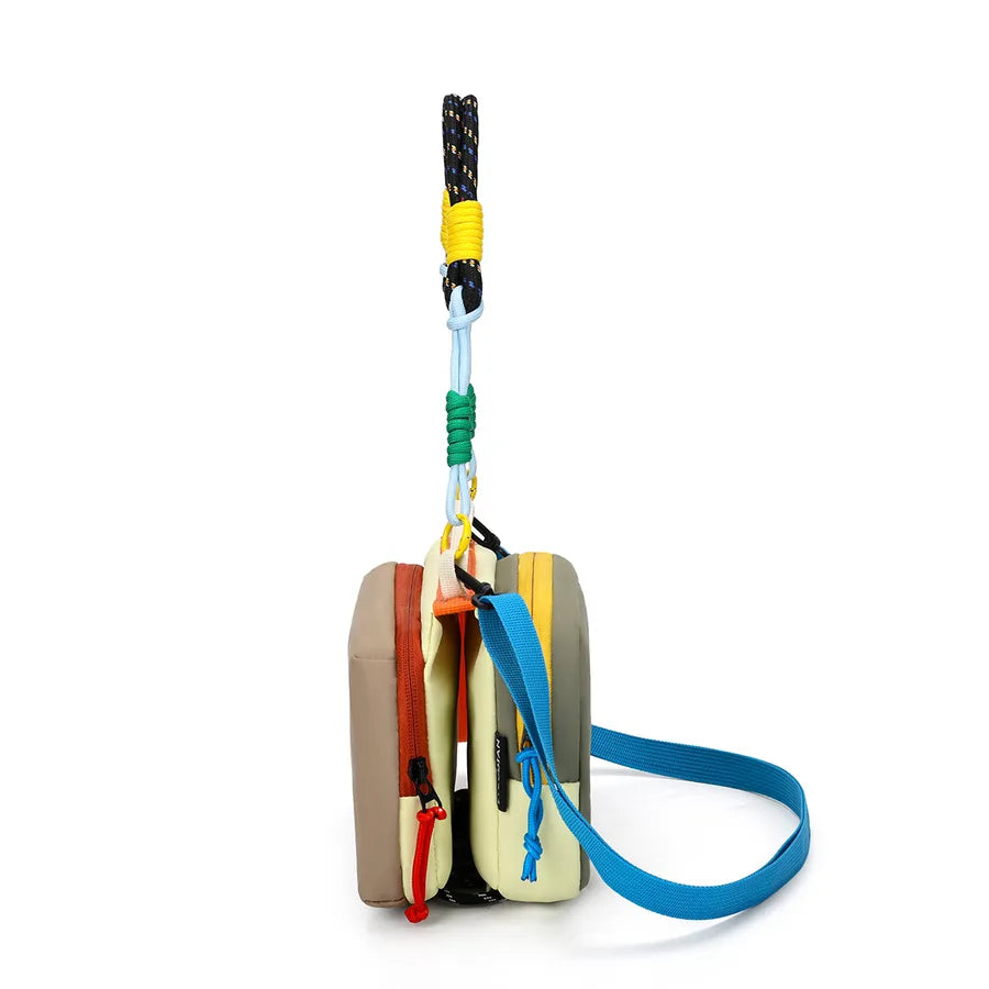 Color-block crossbody bag with rope handle — side view showing slim profile and blue strap | BTendance