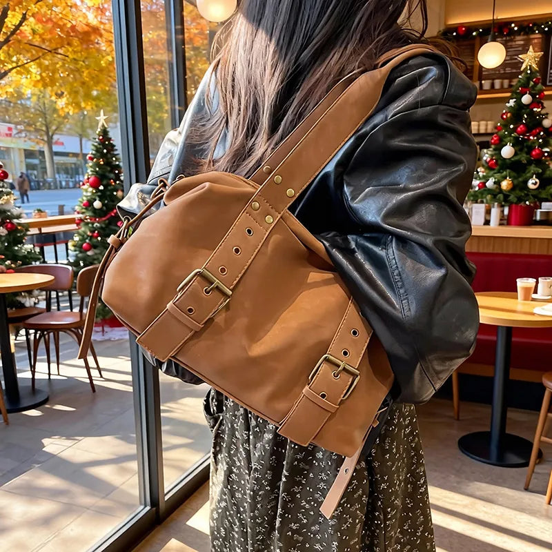 Buckle detail shoulder bag – Tan bag worn with a black jacket | BTendance