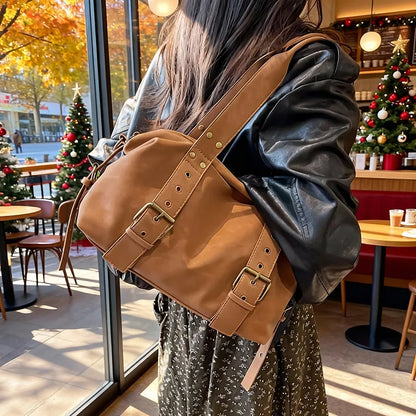 Buckle detail shoulder bag – Tan bag worn with a black jacket | BTendance
