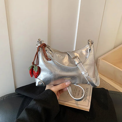 Glossy shoulder bag with strawberry charm – Silver bag, front view in hand | BTendance