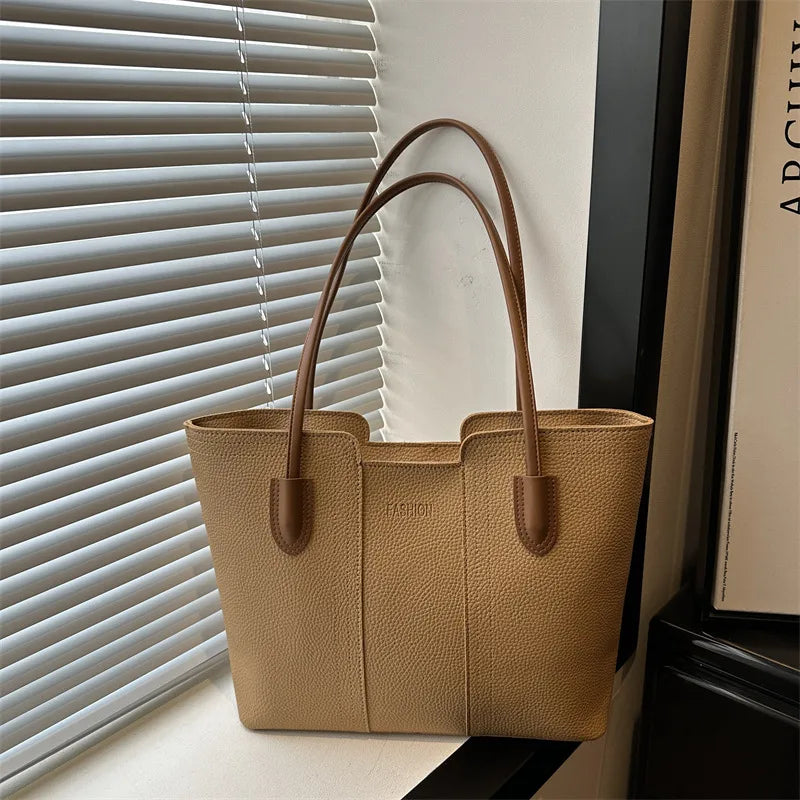 Structured tote bag with long handles – Tan bag beside a window | BTendance