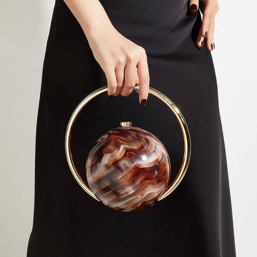 Marbled Globe Evening Bag with Orbit Handle – Brown carried by handle | BTendance