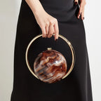 Marbled Globe Evening Bag with Orbit Handle – Brown carried by handle | BTendance