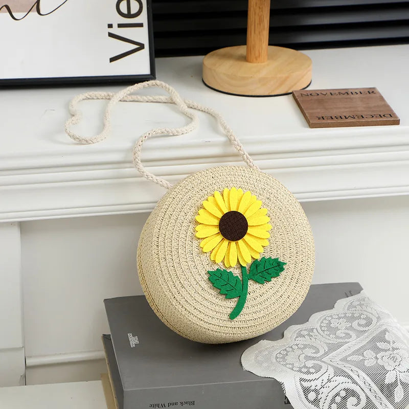 Round woven sunflower crossbody bag – Beige stem and leaf sunflower bag on a display table | BTendance
