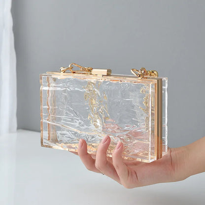 Transparent box bag with gold tone chain – Clear bag held in one hand | BTendance