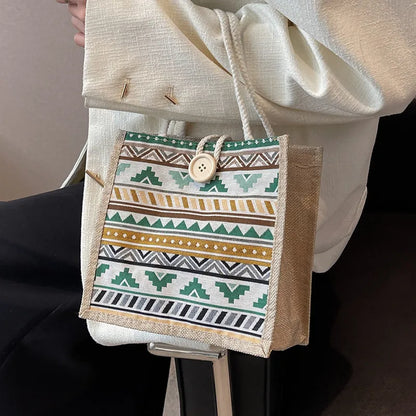 Geometric patterned tote with rope handles – Green accent tote carried beside a cream outfit | BTendance