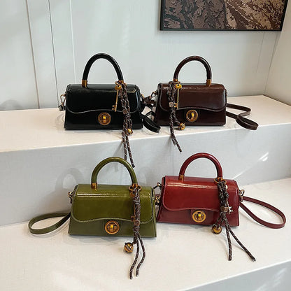 Structured top-handle flap handbag with round gold-tone clasp — four colors grouped on display | BTendance