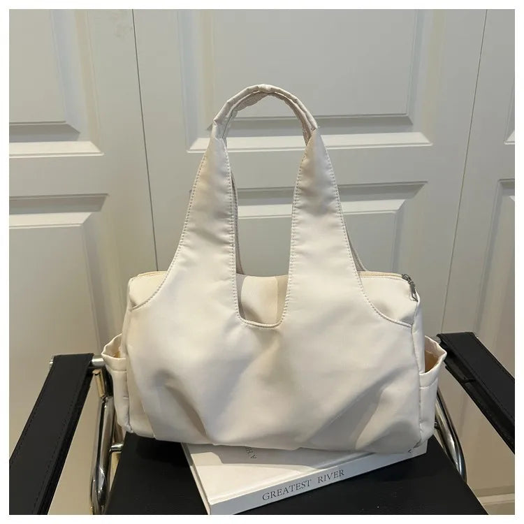 Soft shoulder tote with wide handles and side pockets — white on chair | BTendance