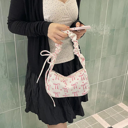 Bow-print corduroy shoulder bag with gathered handle — cream worn on shoulder | BTendance
