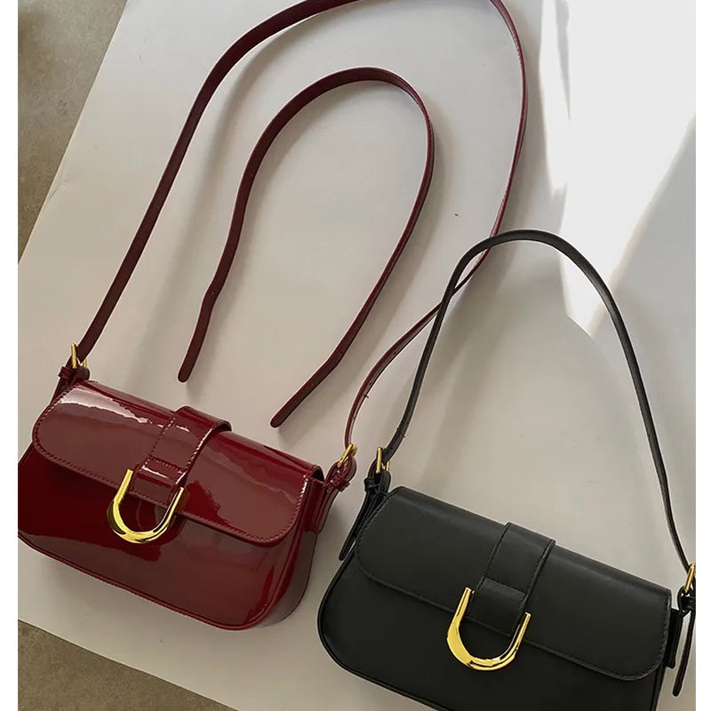 Flap shoulder bag with gold tone U clasp – Red and black bags laid together | BTendance