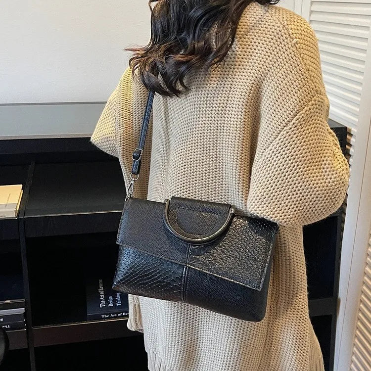 Structured handbag with contrasting reptile-texture panels — dark version worn crossbody | BTendance