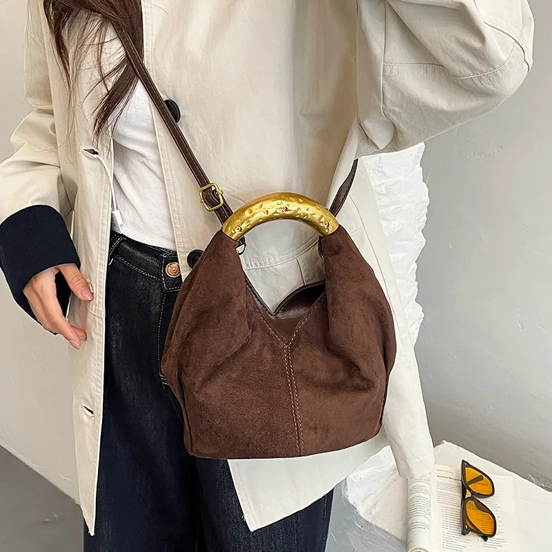 Suede-look bucket handbag with curved gold-tone handle — dark brown worn crossbody | BTendance