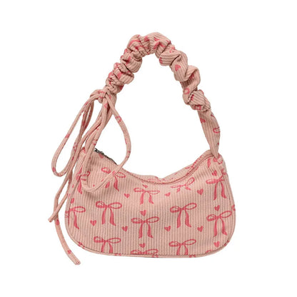 Bow-print corduroy shoulder bag with gathered handle — pink front view on white background | BTendance