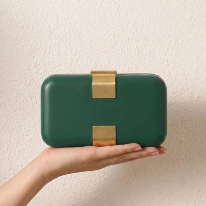 Rectangular evening clutch — green held in one hand | BTendance