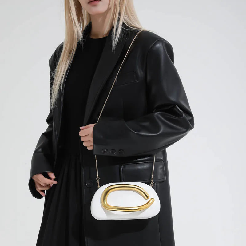 Women's Oval Faux Leather Clutch with Sculptural Metal Accent – White worn crossbody | BTendance