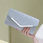 Pleated Envelope Evening Clutch with Metallic Trim – Silver held for scale | BTendance