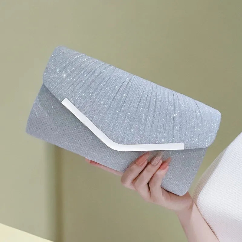 Pleated Envelope Evening Clutch with Metallic Trim – Silver held for scale | BTendance