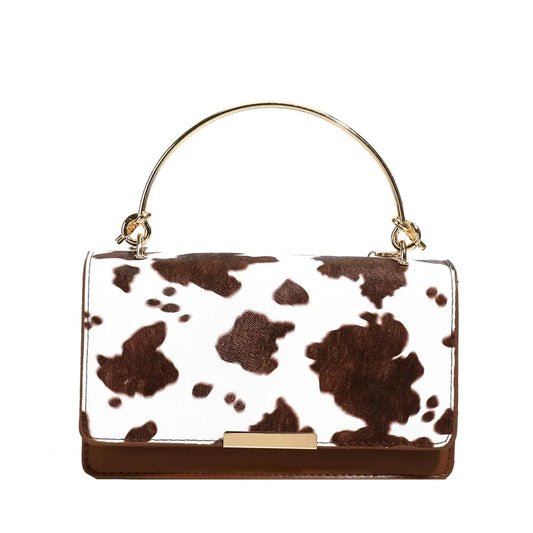 Cow print handbag with metal top handle – Brown cow print bag on white background | BTendance