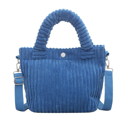 Ribbed plush handbag with rounded handles and long strap — blue front view on white background | BTendance