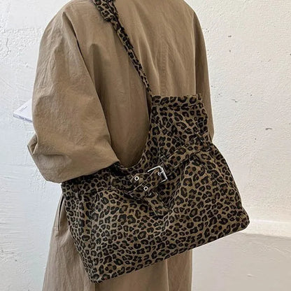 Leopard-print shoulder tote with front buckle detail — worn on shoulder | BTendance