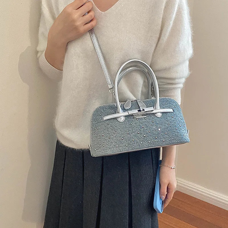 Denim handbag with silver-tone handles and shoulder strap — dotted embellishments worn crossbody | BTendance