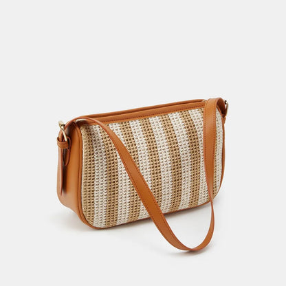 Striped woven shoulder bag with tan trim – Angled view with strap resting in front | BTendance