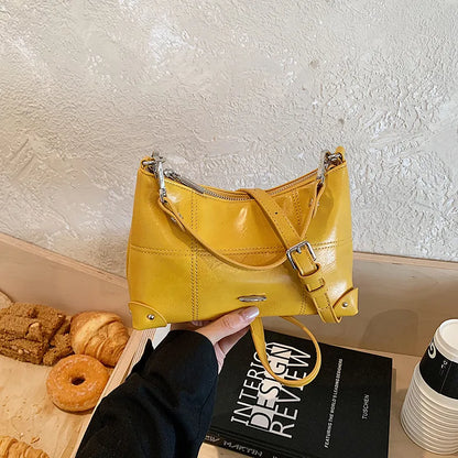 Glossy shoulder bag with strawberry charm – Yellow bag, side angle in hand | BTendance