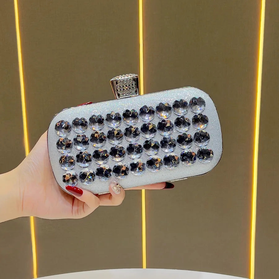 Women's Faceted Rhinestone Evening Clutch with Chain – Silver held for scale | BTendance