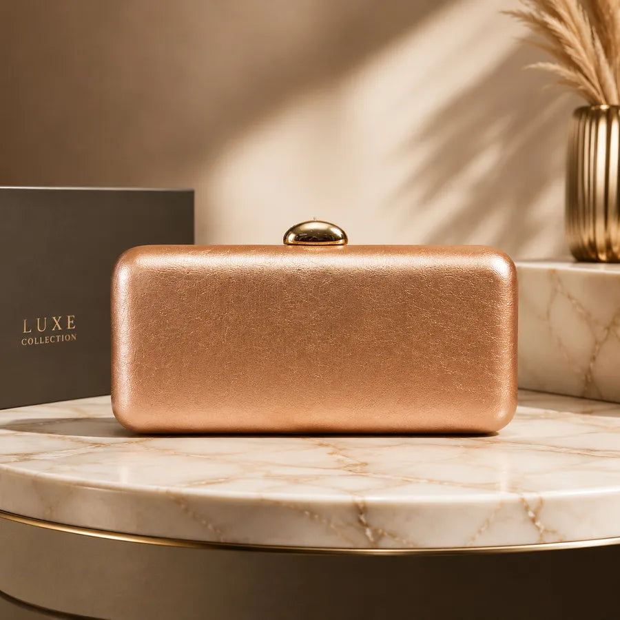 Rectangular evening clutch with oval metal clasp — copper on marble display | BTendance