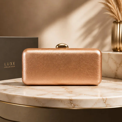 Rectangular evening clutch with oval metal clasp — copper on marble display | BTendance