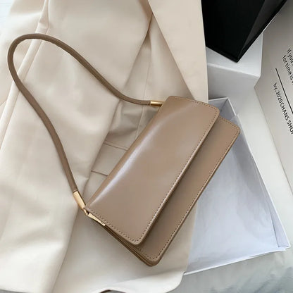 Slim rectangular flap shoulder bag with gold-tone strap accents — taupe on cream fabric | BTendance