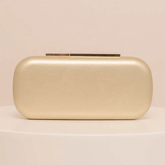 Gold rectangular evening clutch with bar clasp — front view on display plinth | BTendance