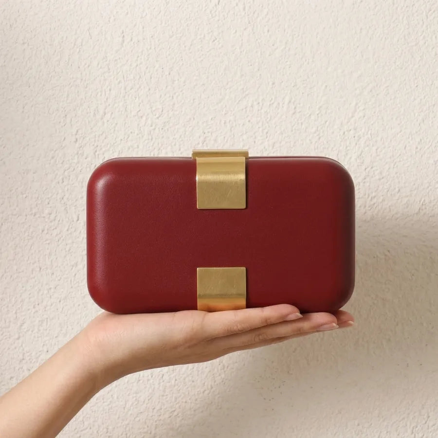 Rectangular evening clutch — red held in one hand | BTendance